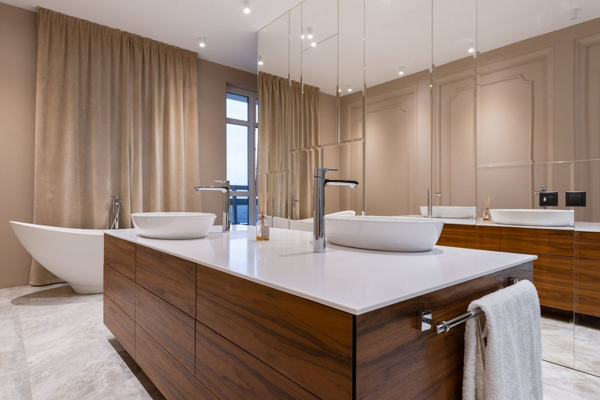 Twin basins on a run of vanity units — the sort of layout that needs the pipework thought through before the tiling is set out.